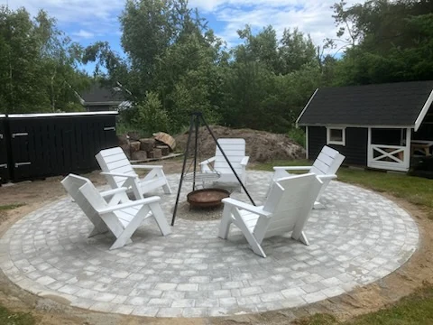 Færdig bålplads med havestole omkring bålfadet
